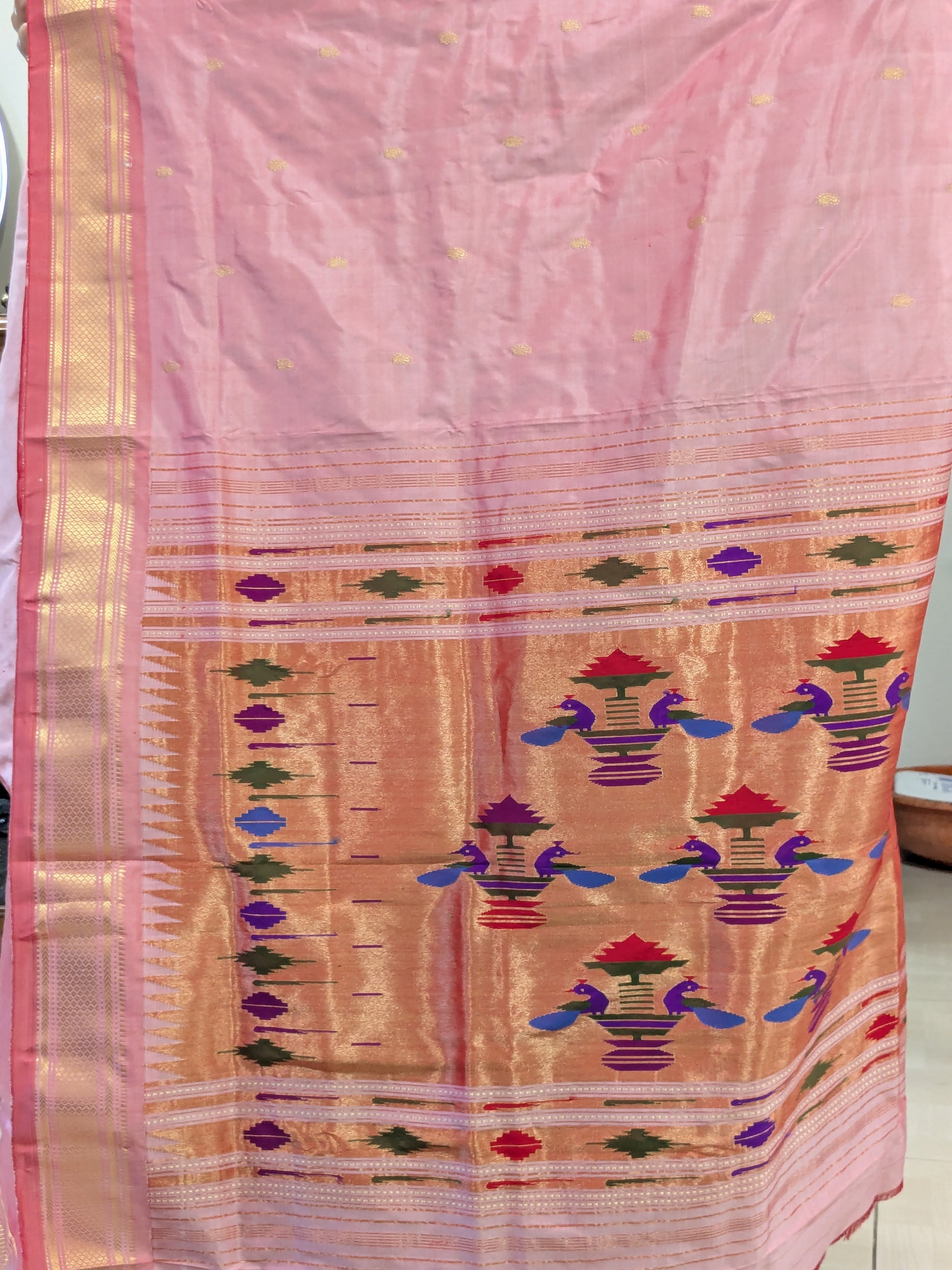 Detailed pallu shot with resplendent peacocks woven in classic Paithani style.