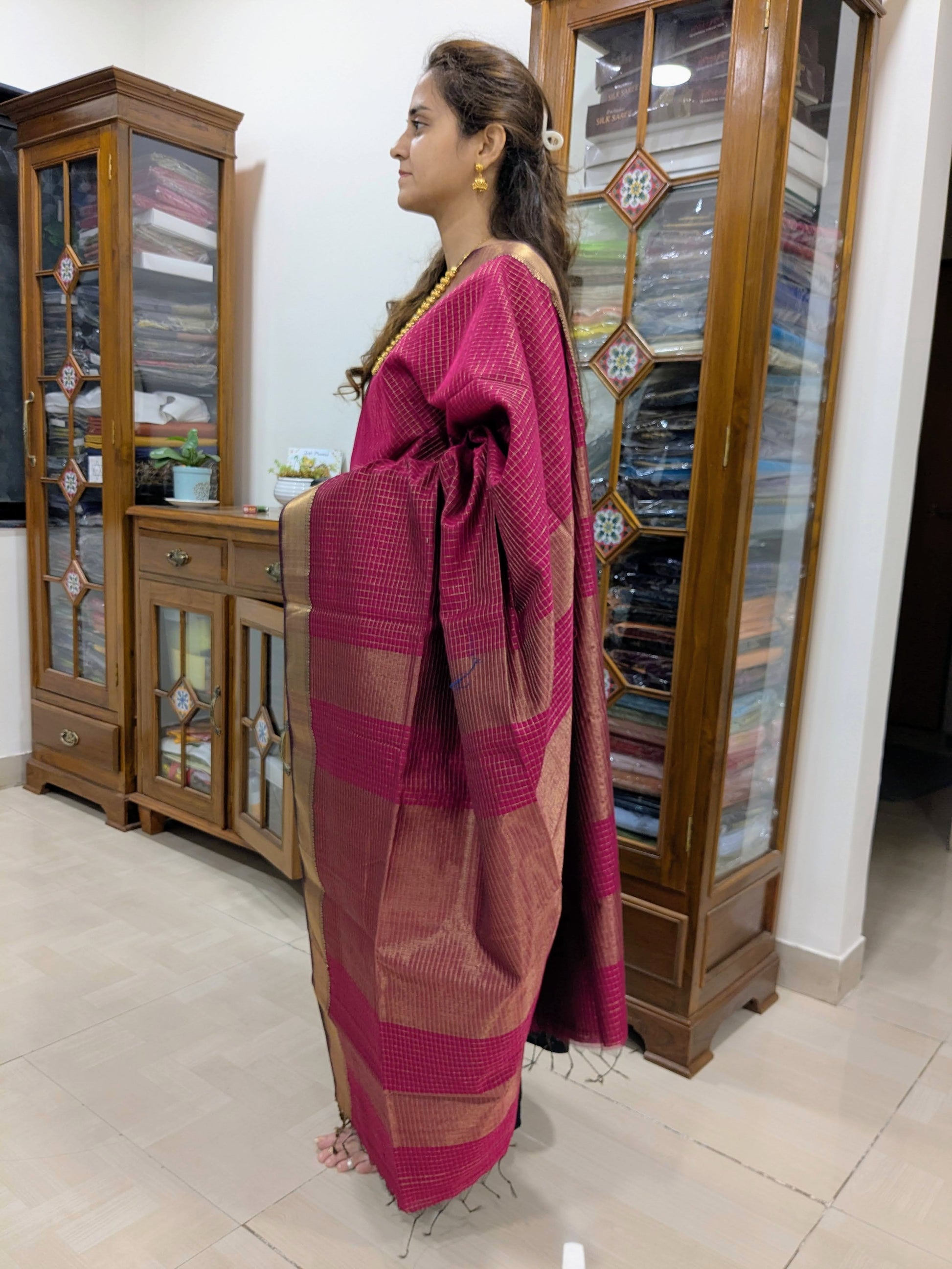 Side view capturing fluid drape, sheen of zari, and fine handloom craftsmanship.