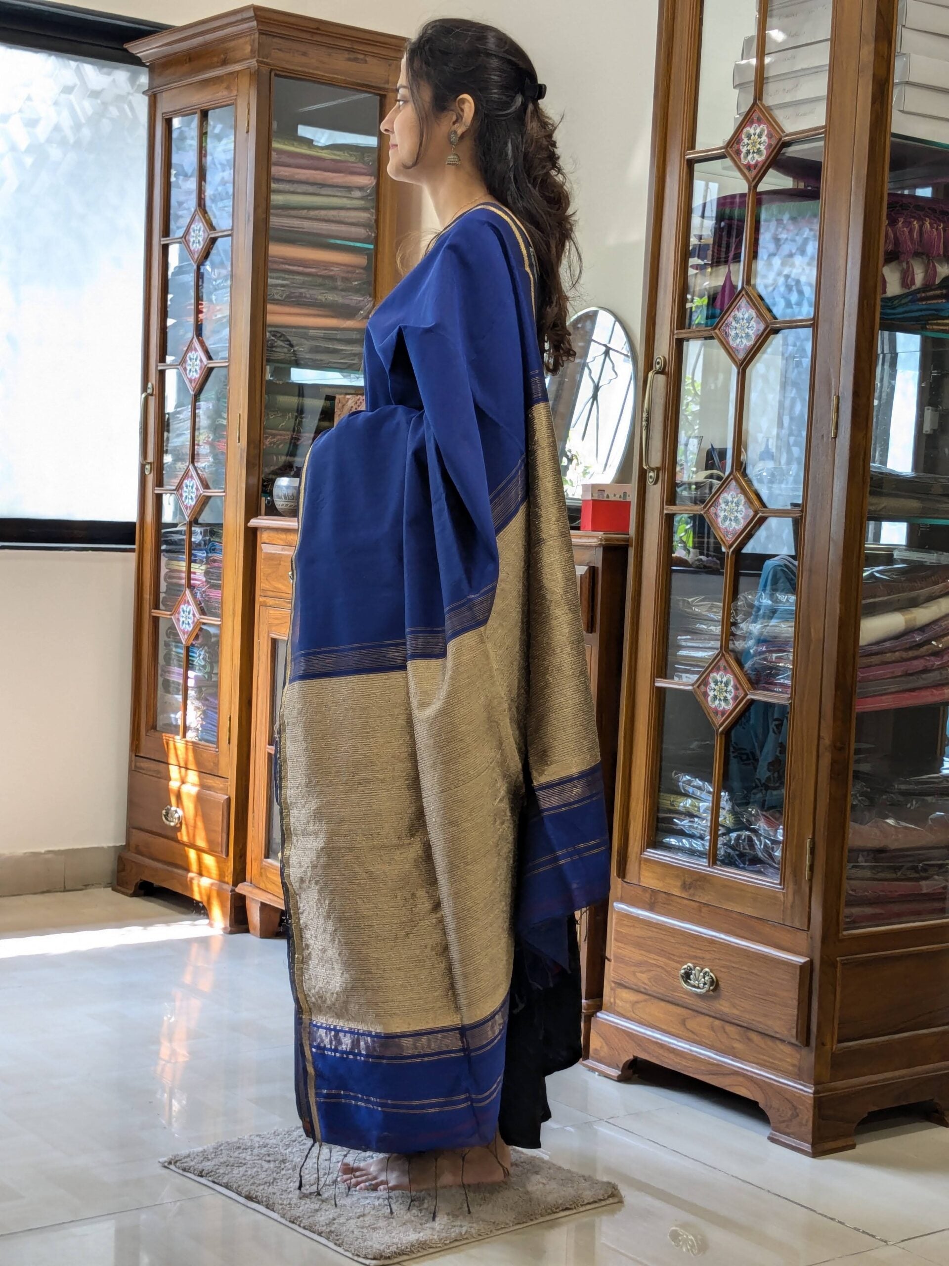 Side view of royal blue saree showing soft drape, smooth texture, and understated sophistication. 