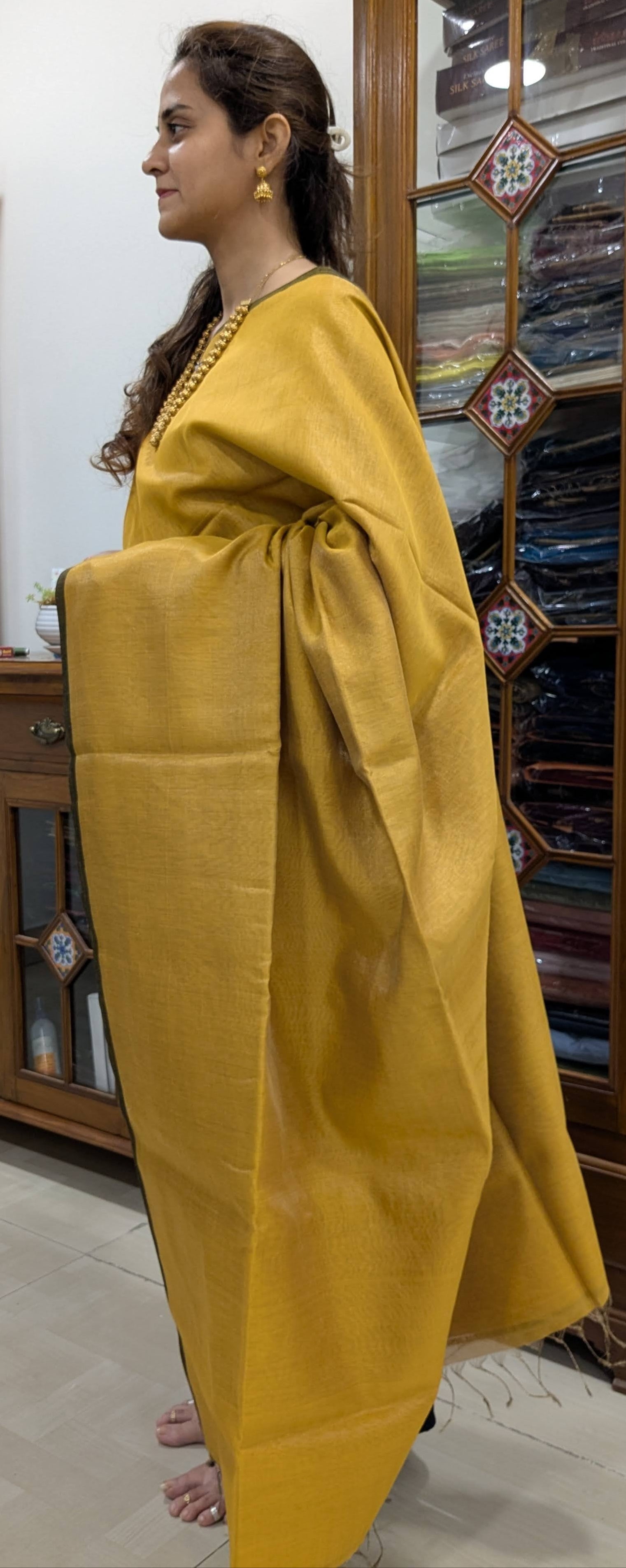 Side view capturing the soft texture and elegant drape of the plain Maheshwari weave.