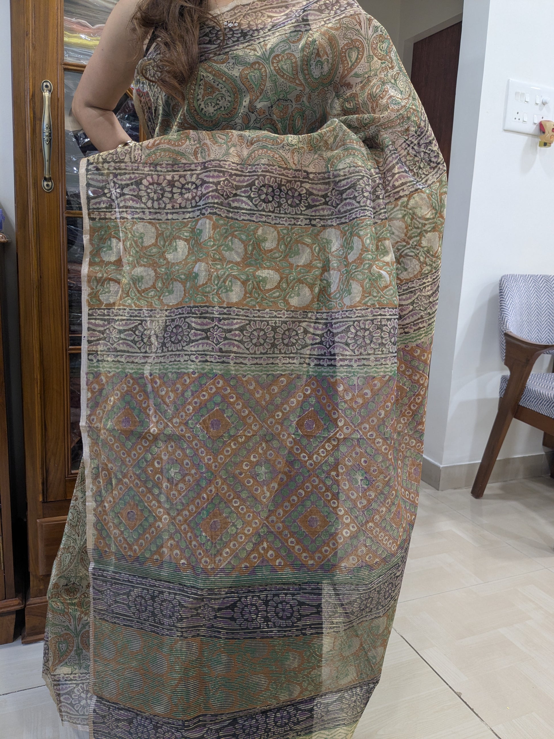 Golden Chanderi silk saree featuring elegant hand block printed flower trails, radiating festive charm.