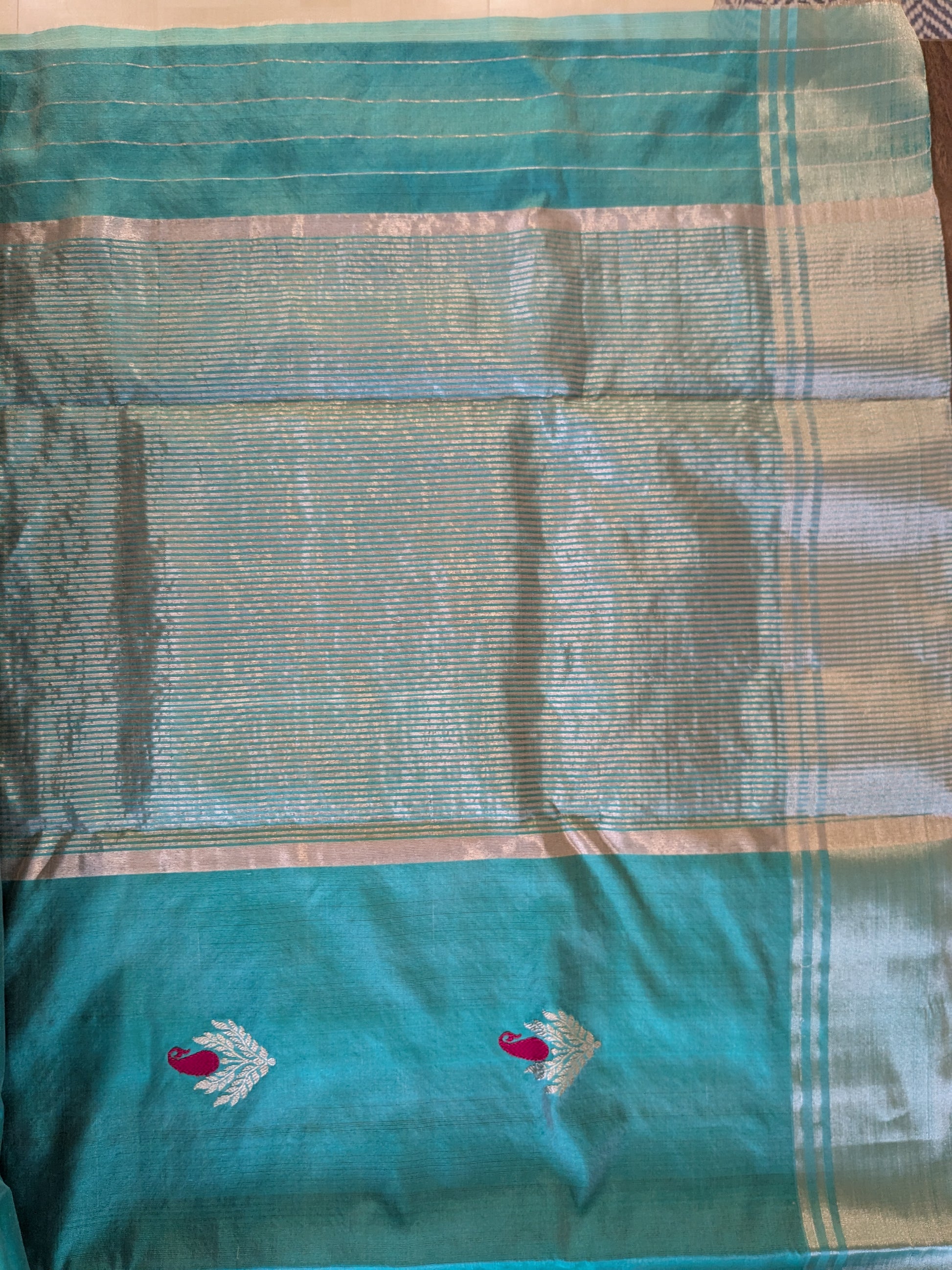 Detailed image of heavy pallu with ornate floral weaving and traditional detailing.