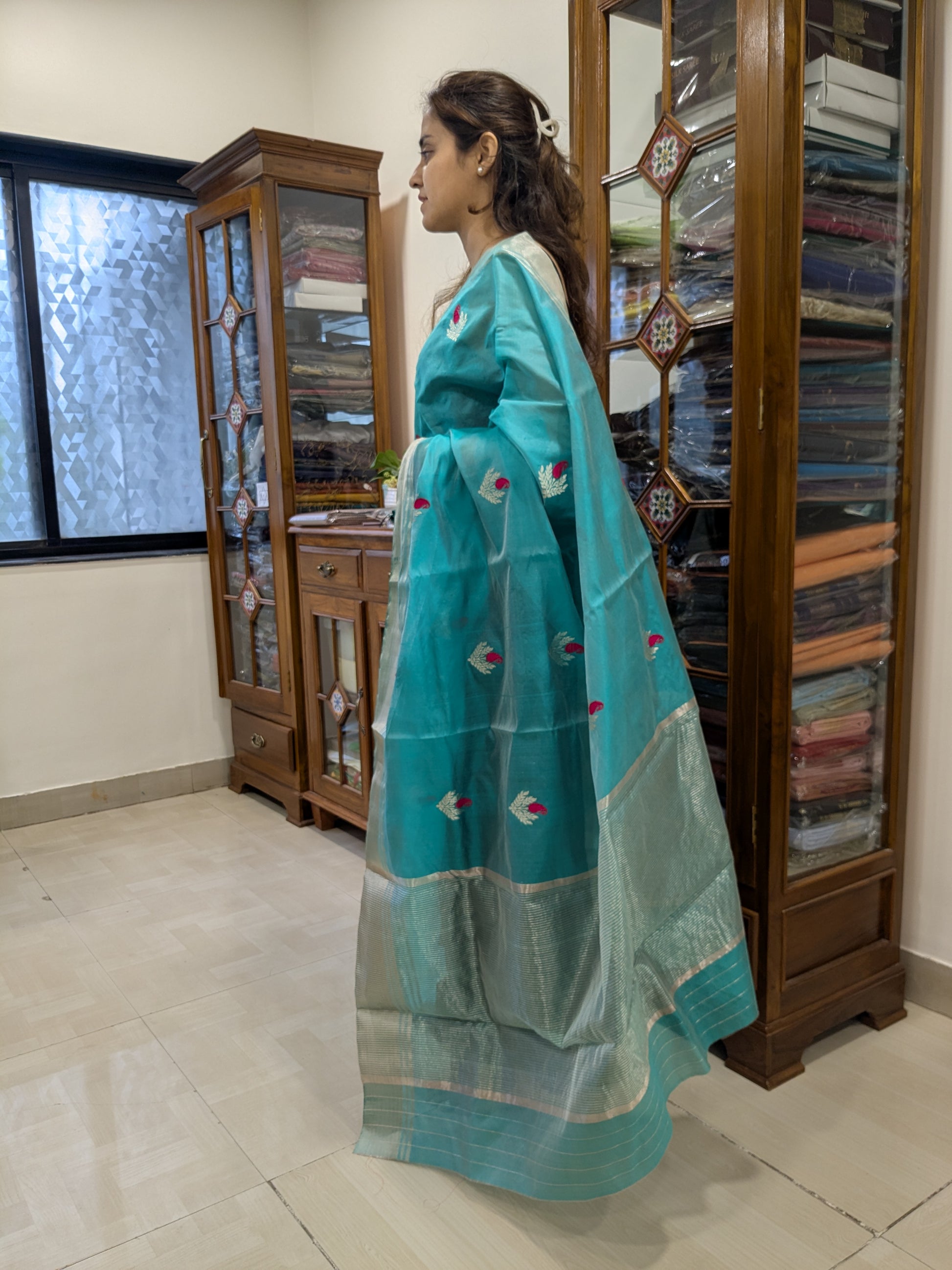 Side view of rama green Chanderi saree showing graceful drape, sheer silk finish, and elegant craftsmanship.