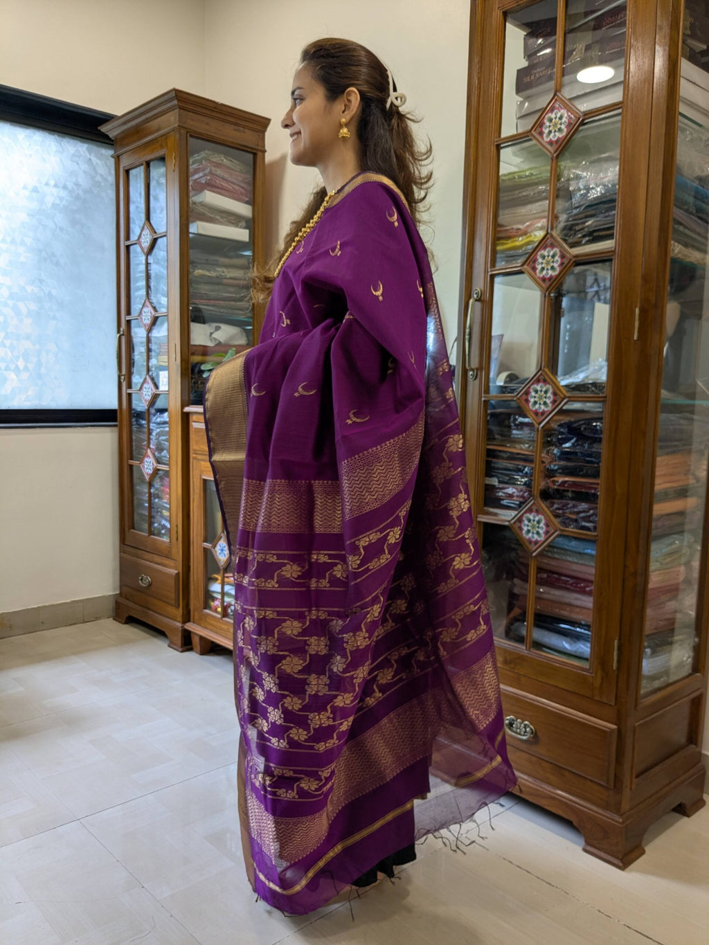 Side view of magenta saree showing elegant drape, textured weave, and intricate motif detailing. 