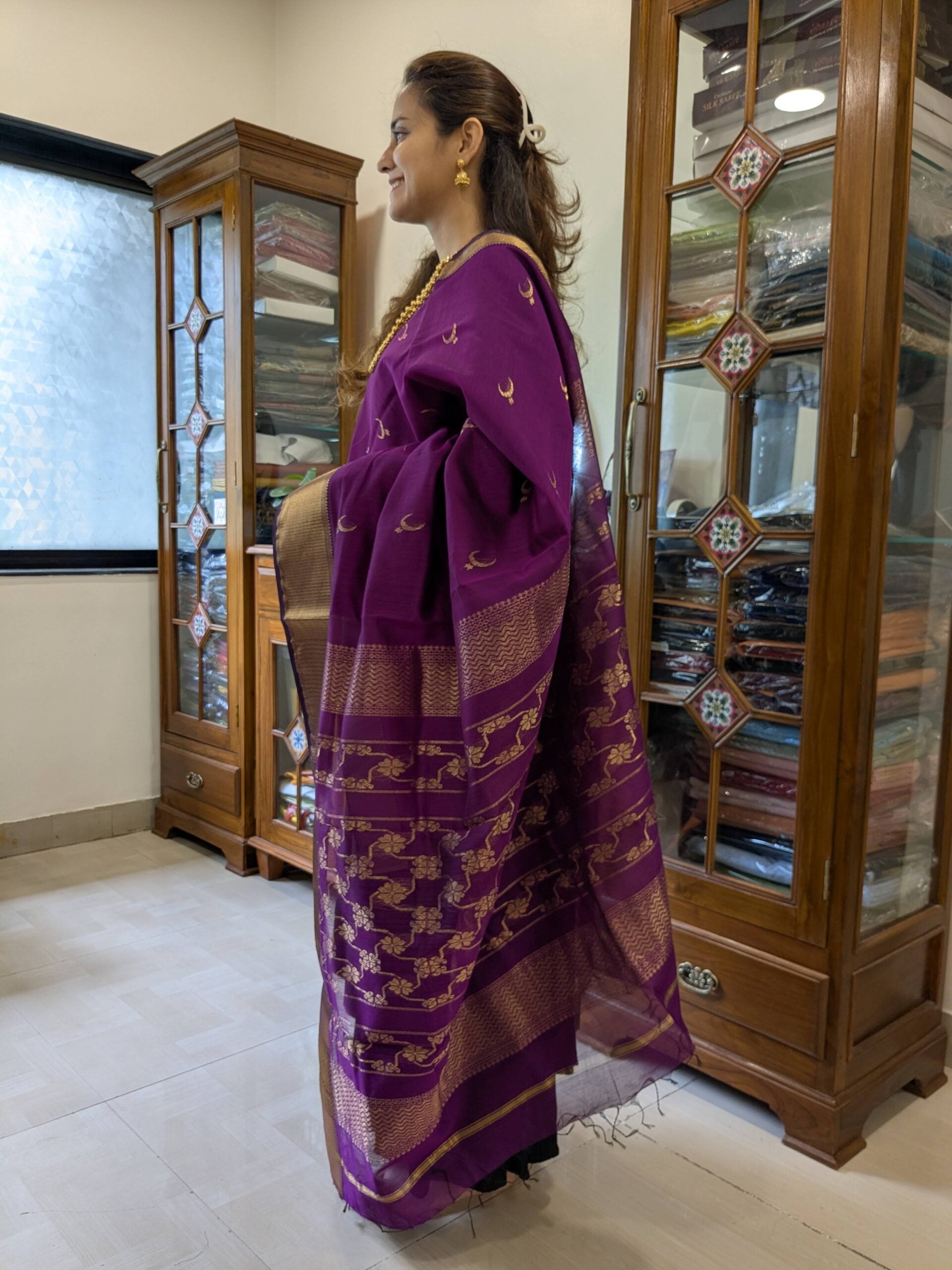 Side view of magenta saree showing elegant drape, textured weave, and intricate motif detailing. 