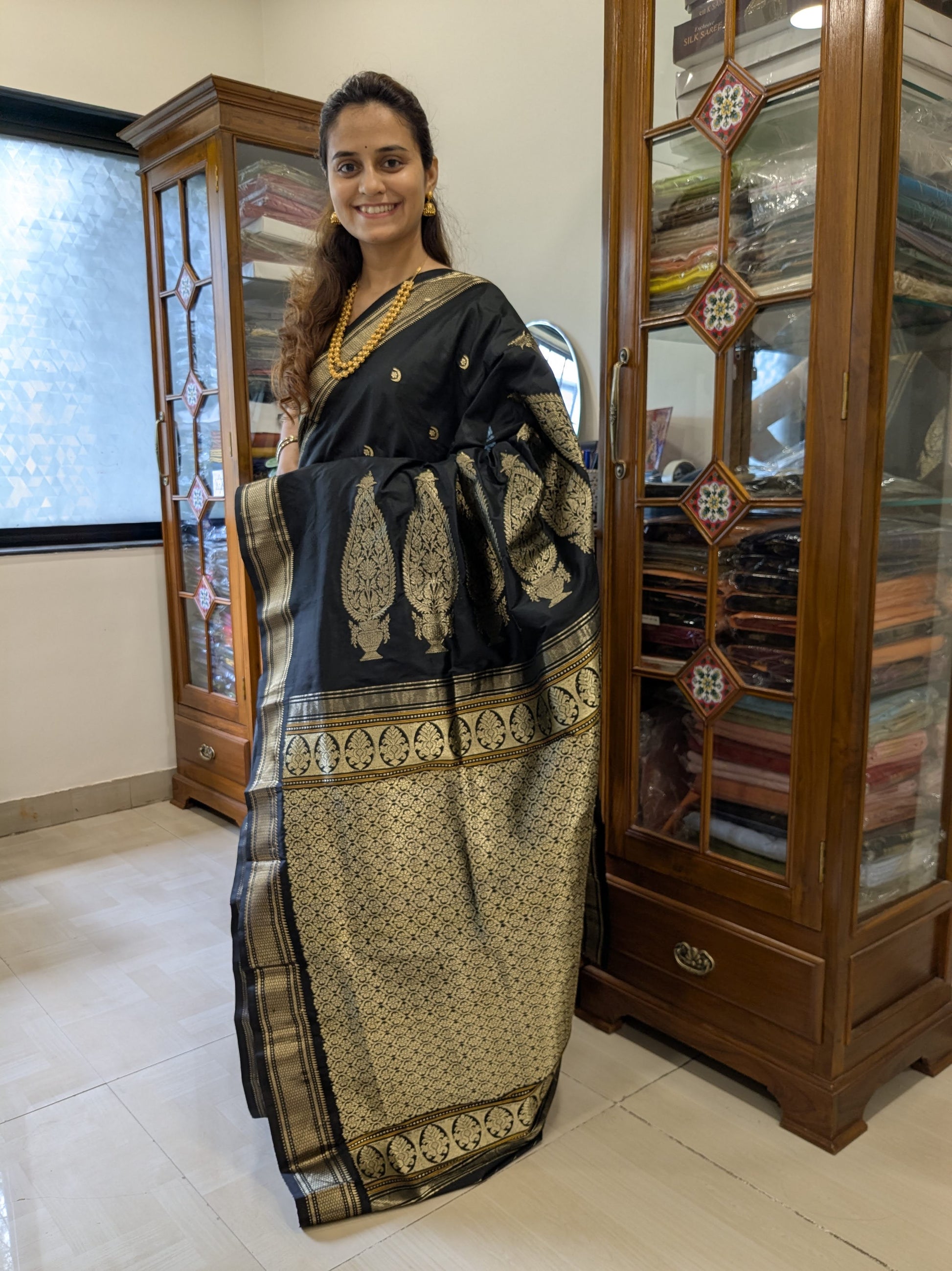 Full front view of luxurious black handloom Paithani saree featuring intricate floral and lunar patterns in rich silk.