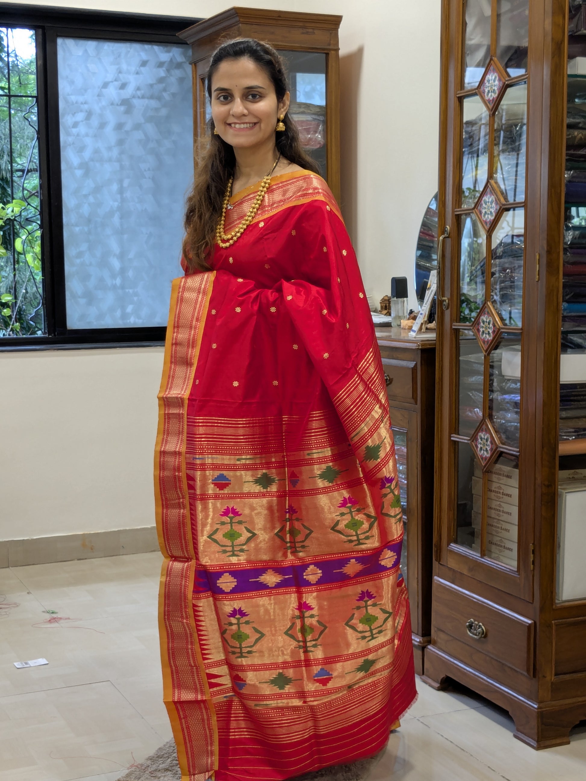 Full front view of vibrant fresh red Paithani saree perfect for bridal elegance.