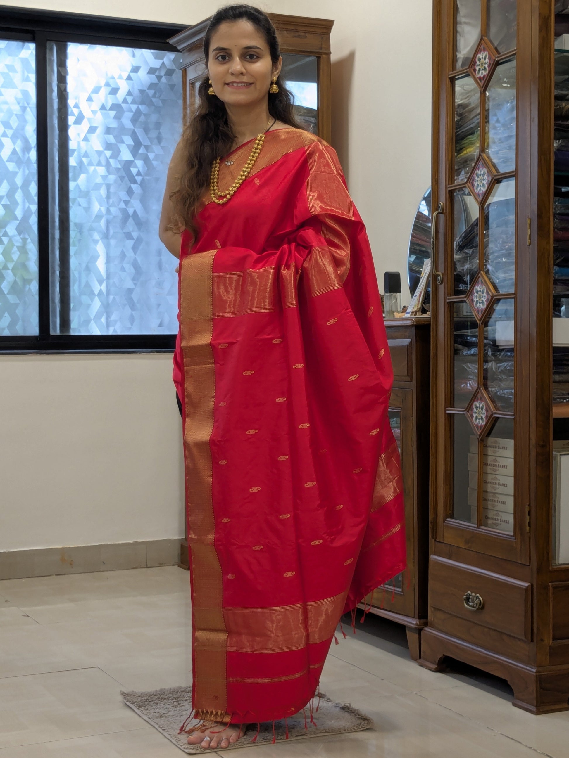 Full front view of bridal-festive Tomato Red Maheshwari saree in handwoven silk.
