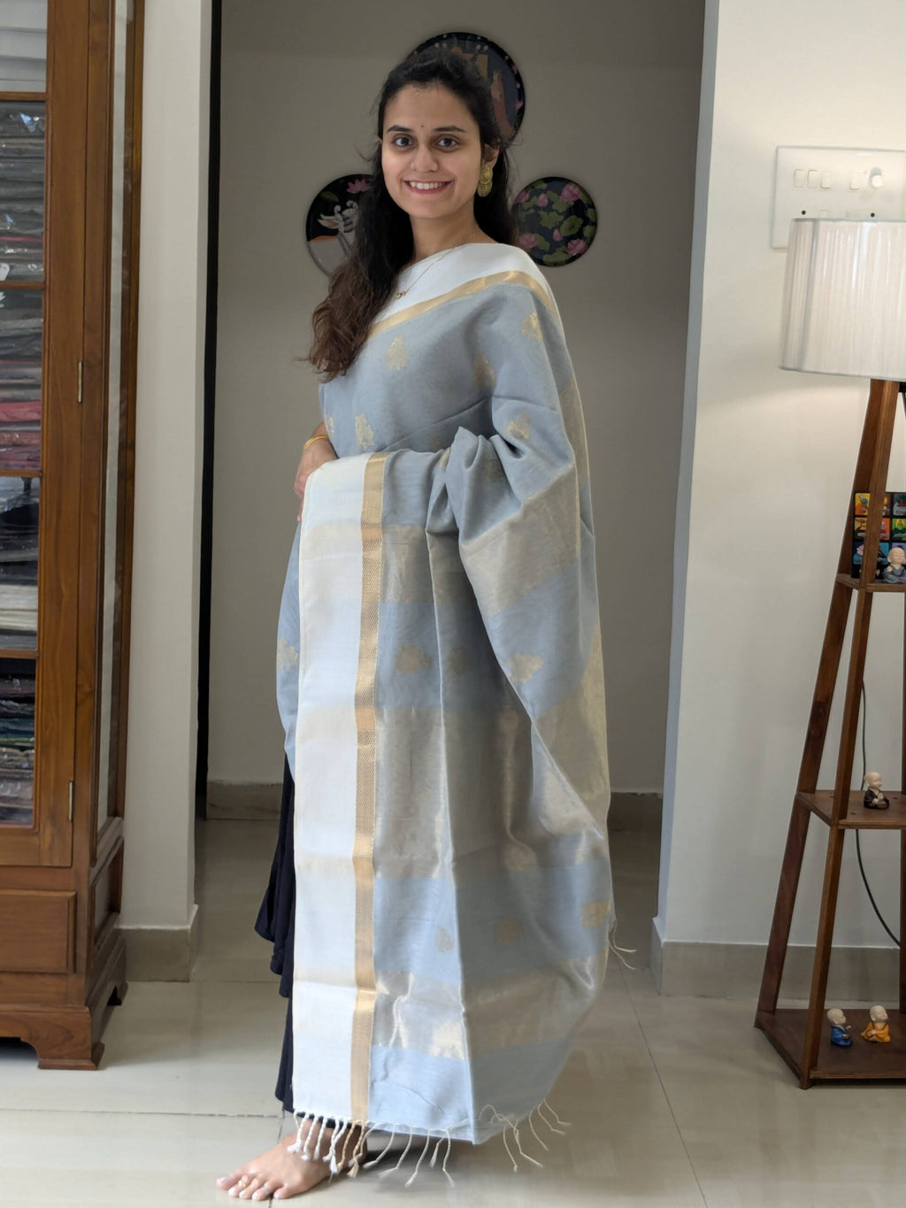 Full front view of elegant grey handloom Maheshwari saree featuring floral design and subtle zari accents.