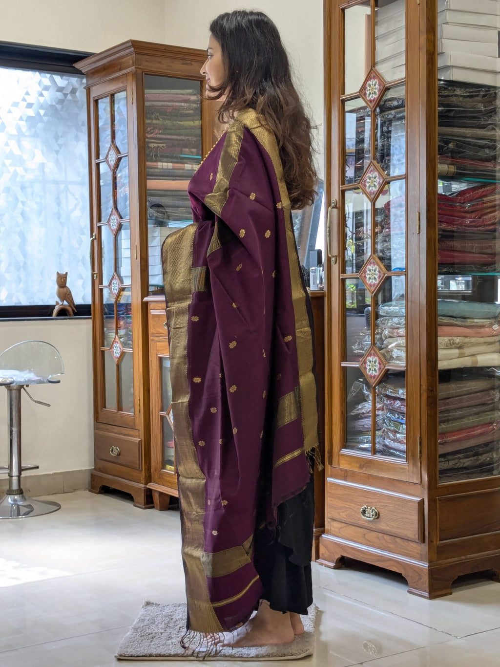 Side view of handloom silk cotton saree in plum purple showing elegant drape and texture.