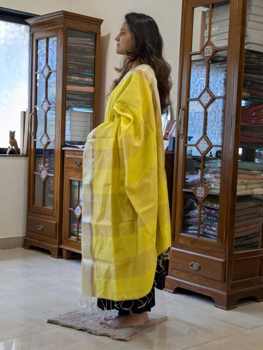 Side view of fluorescent yellow saree showcasing smooth drape, handwoven texture, and subtle traditional elegance. 