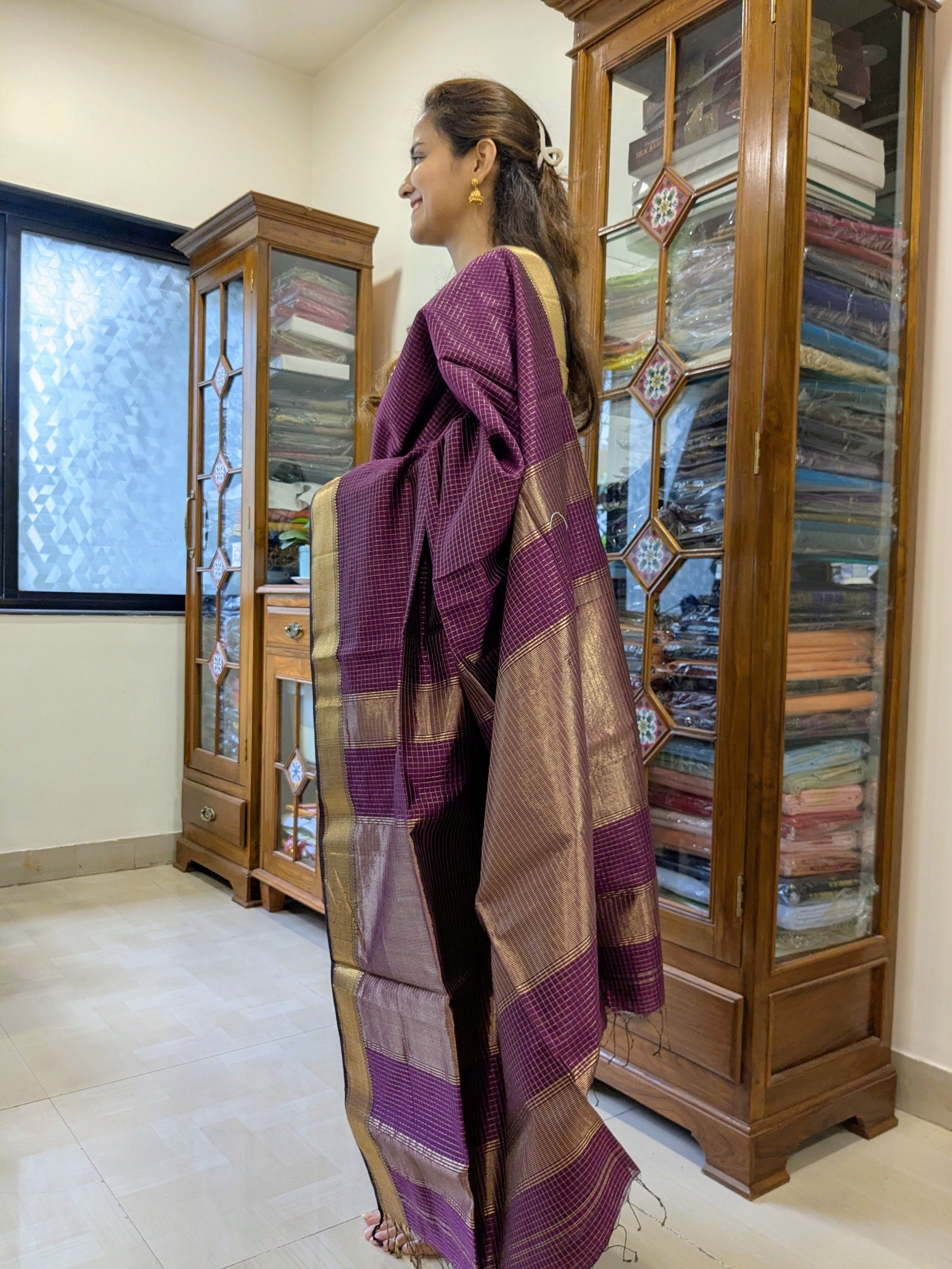 Side view of wine saree showcasing smooth drape, elegant handwoven finish, and classic zari detailing.