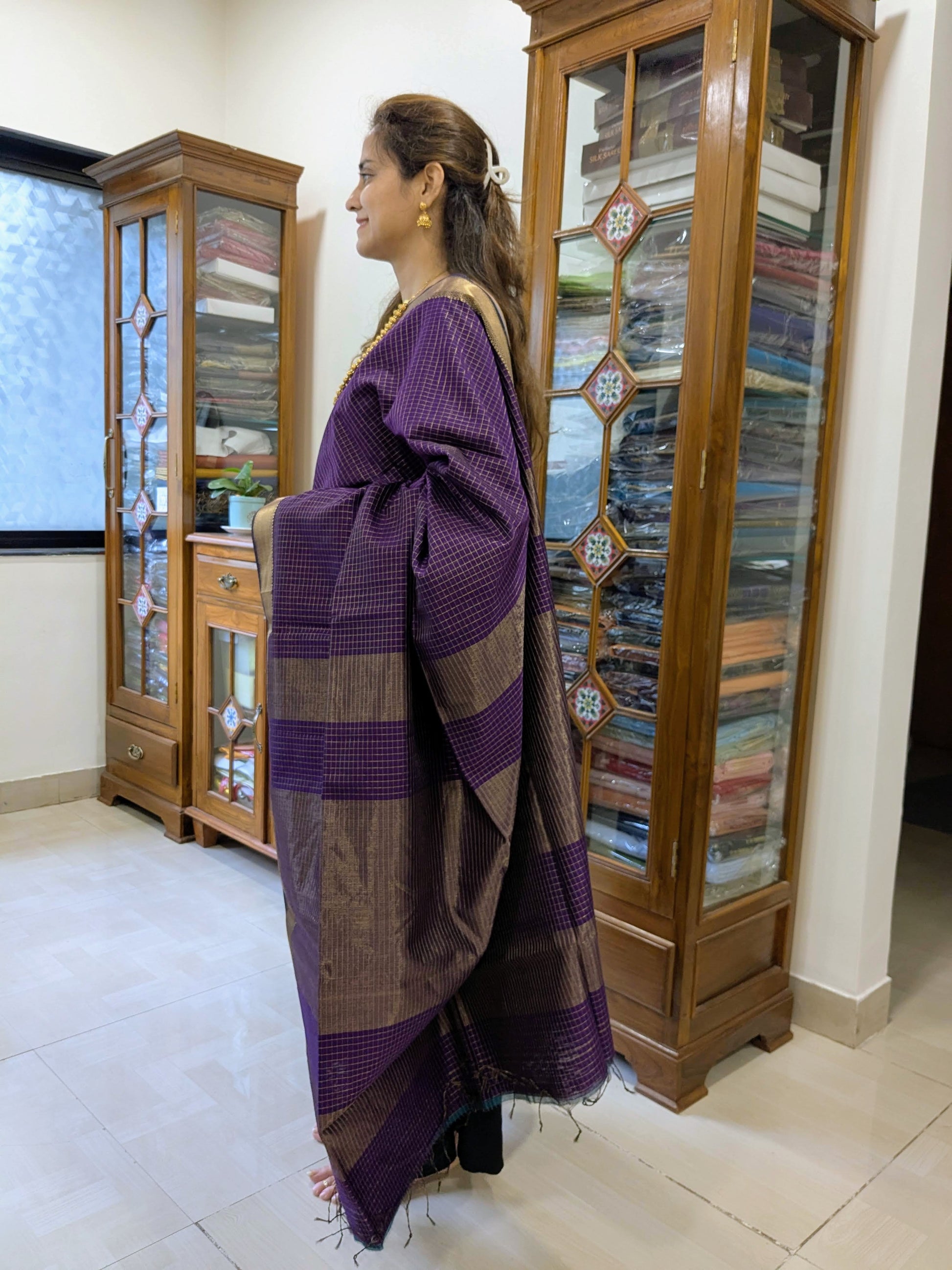 Side view of purple saree showing fluid drape, lustrous finish, and traditional handwoven detail.