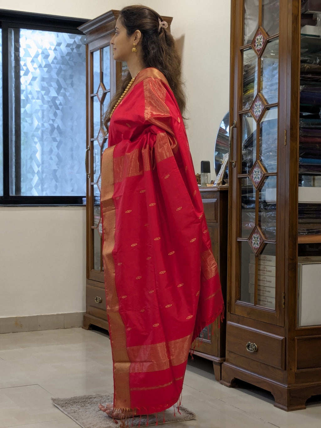 Side view highlighting smooth silk drape, detailed motifs, and jaali craftsmanship.