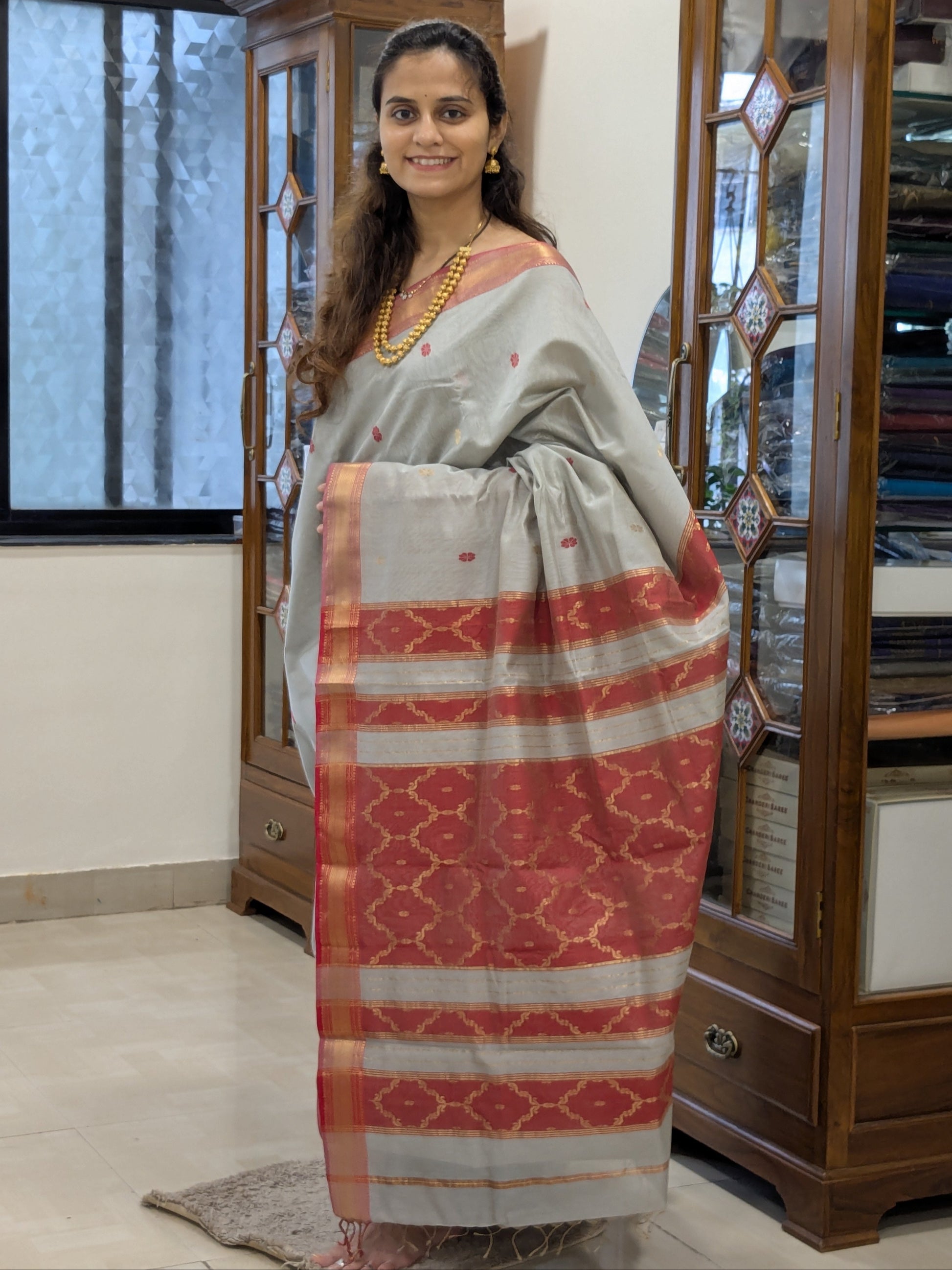 Full front view of festive Silver Grey Maheshwari saree highlighting silk-tissue elegance and traditional weaving.