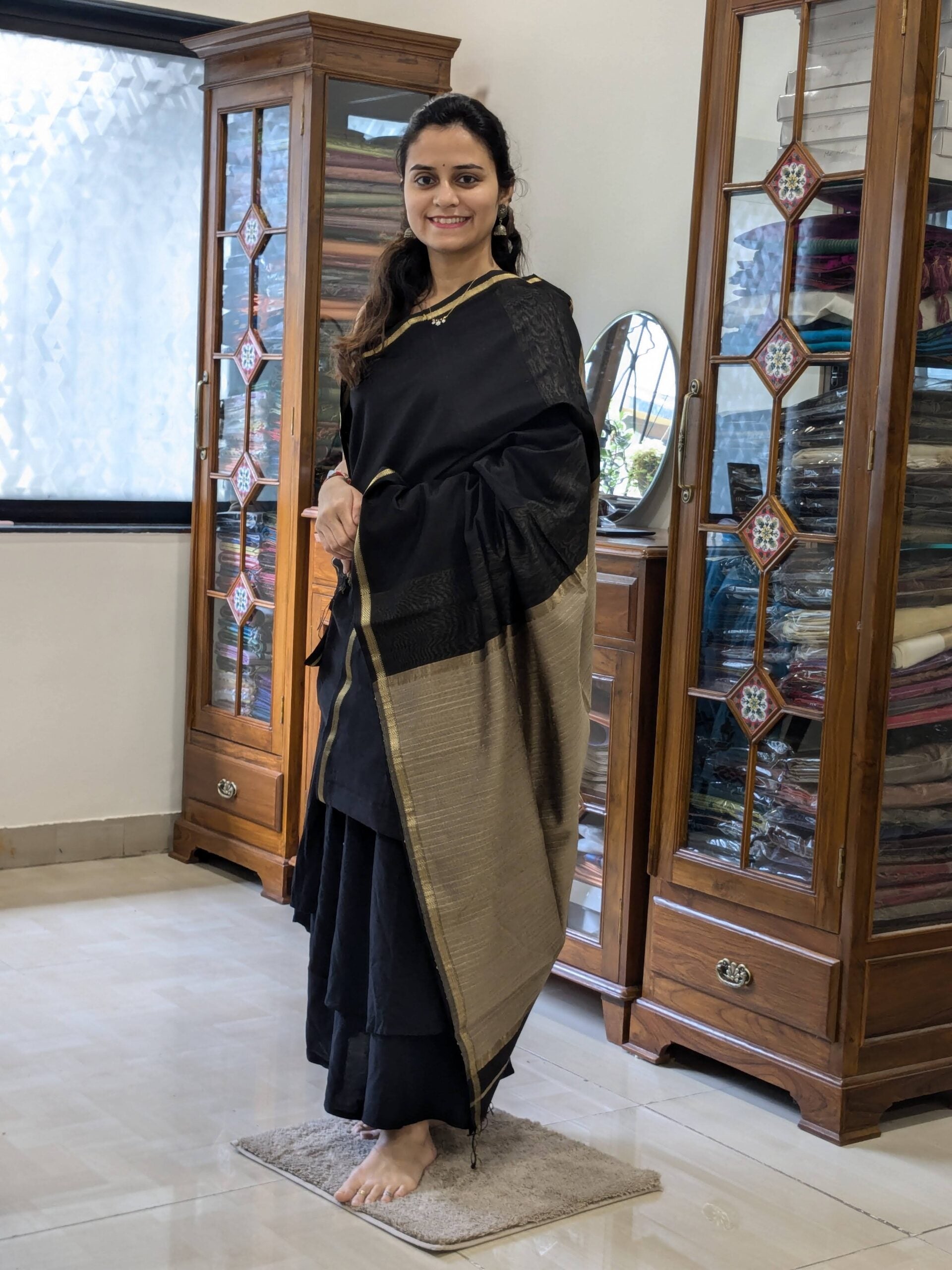 Full front view of elegant black handloom Maheshwari saree featuring minimalist design and refined traditional finish.
