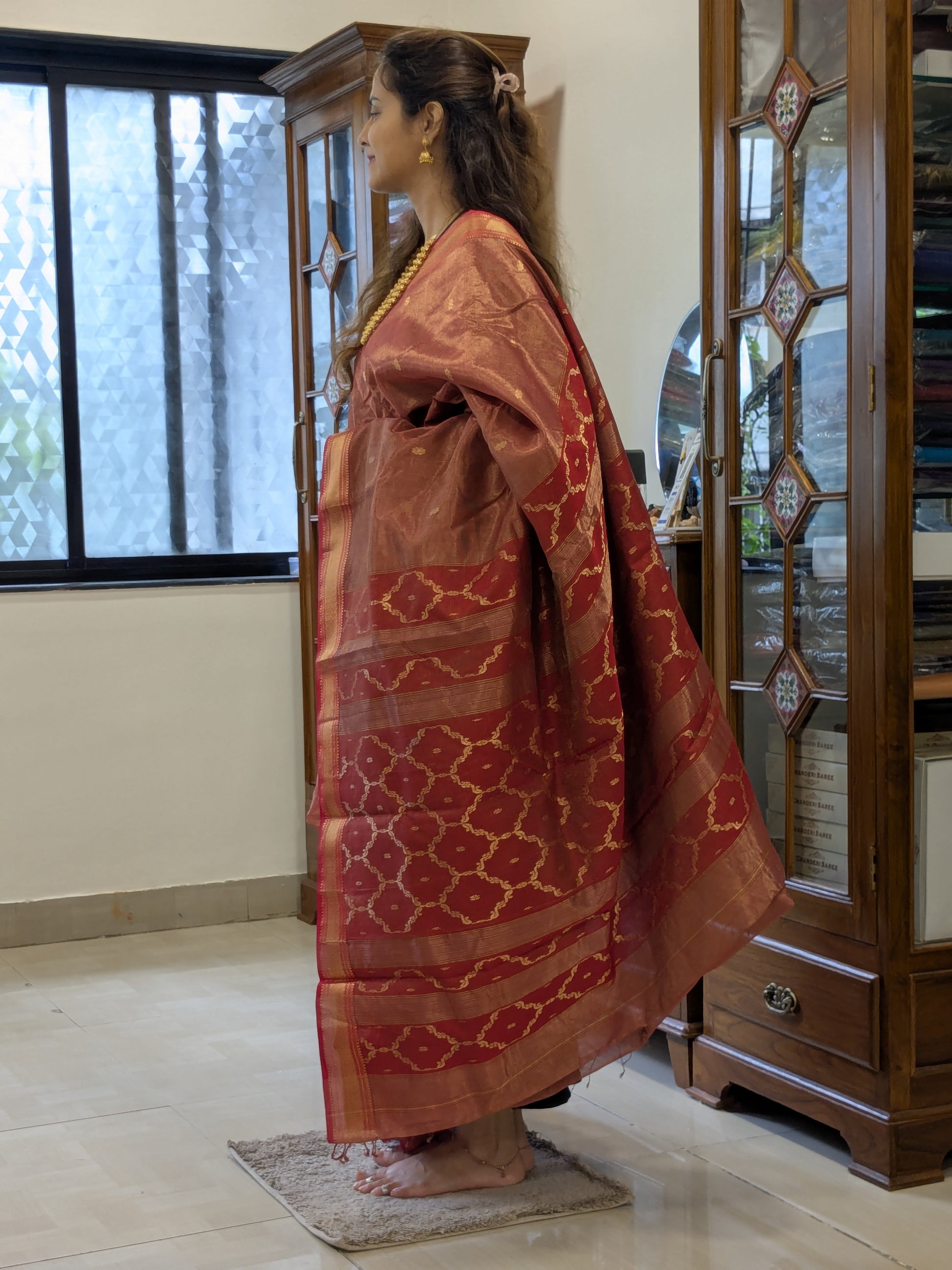 Side view showcasing fluid drape, floral motifs, and handloom artistry.