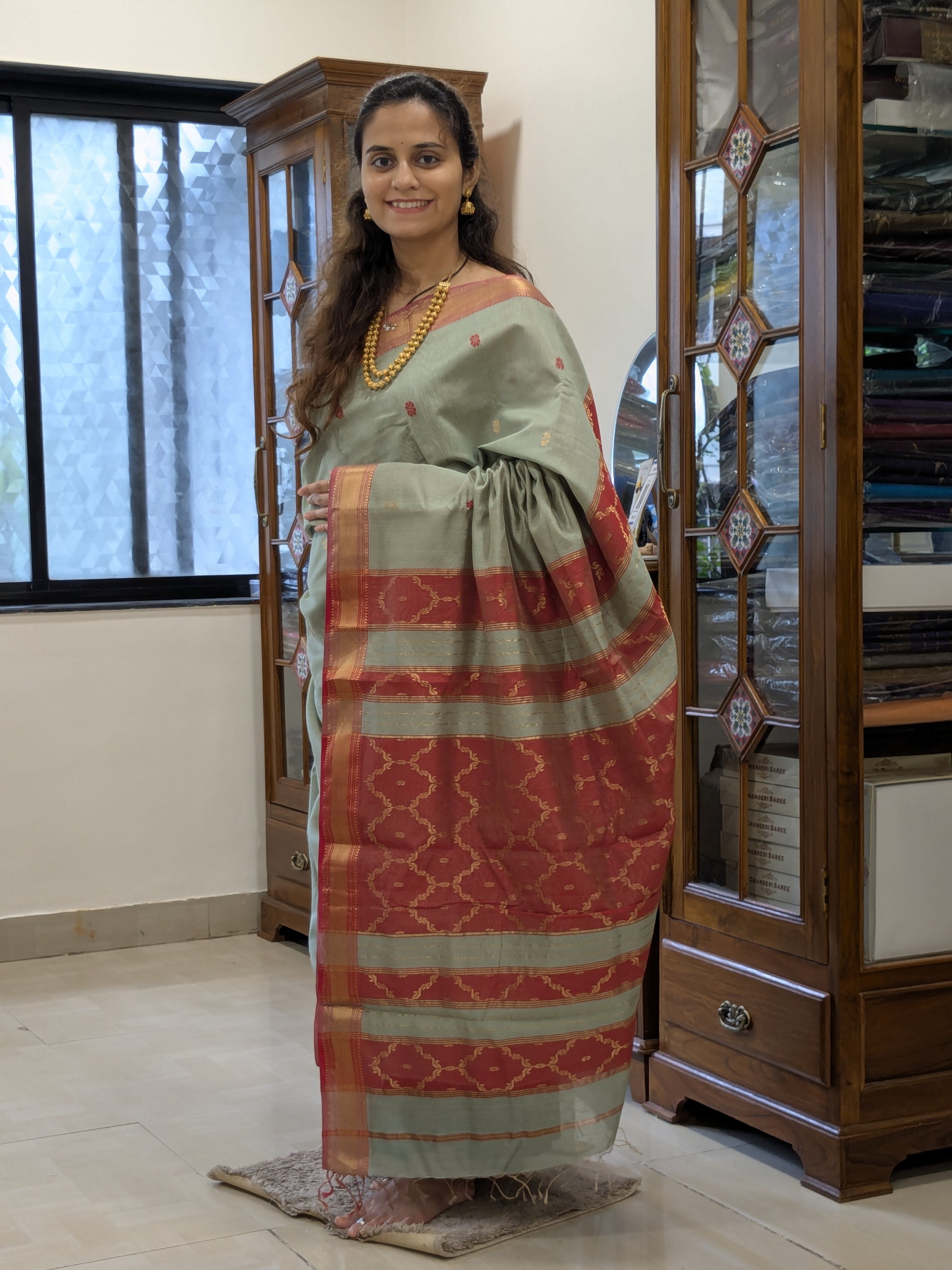 Full front view of festive Sea Mist Maheshwari saree highlighting silk-tissue weave and elegant drape.