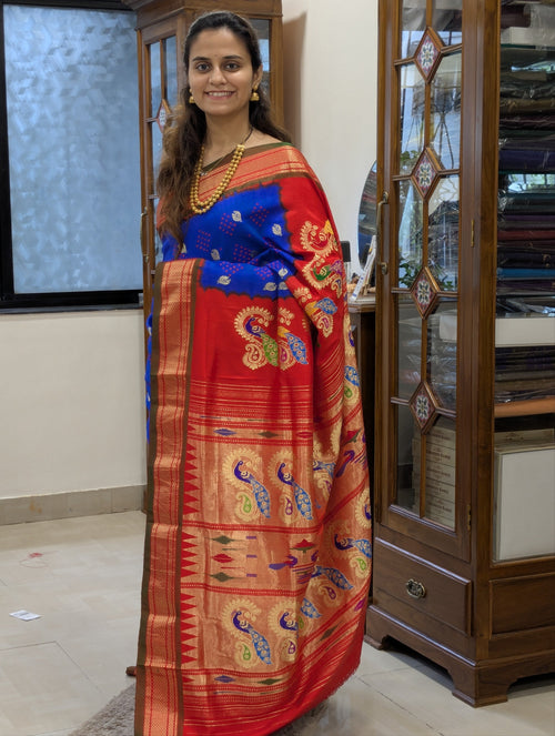 Full front view of elegant royal blue Paithani saree radiating festive charm.
