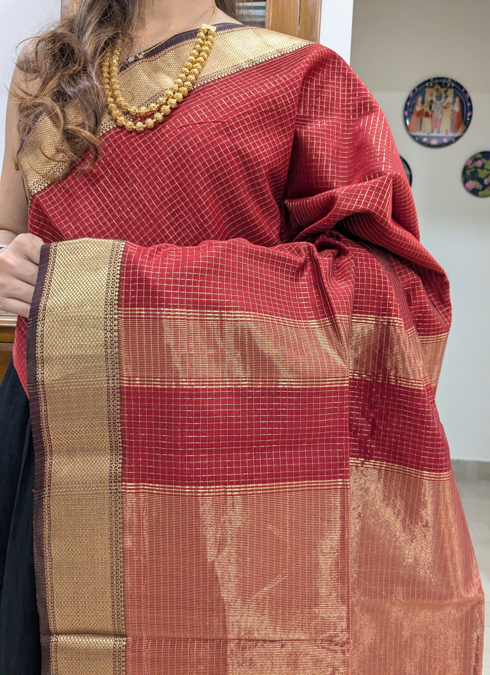 Close-up of fresh red Maheshwari saree in silk-cotton with zari checks and handwoven medium border.