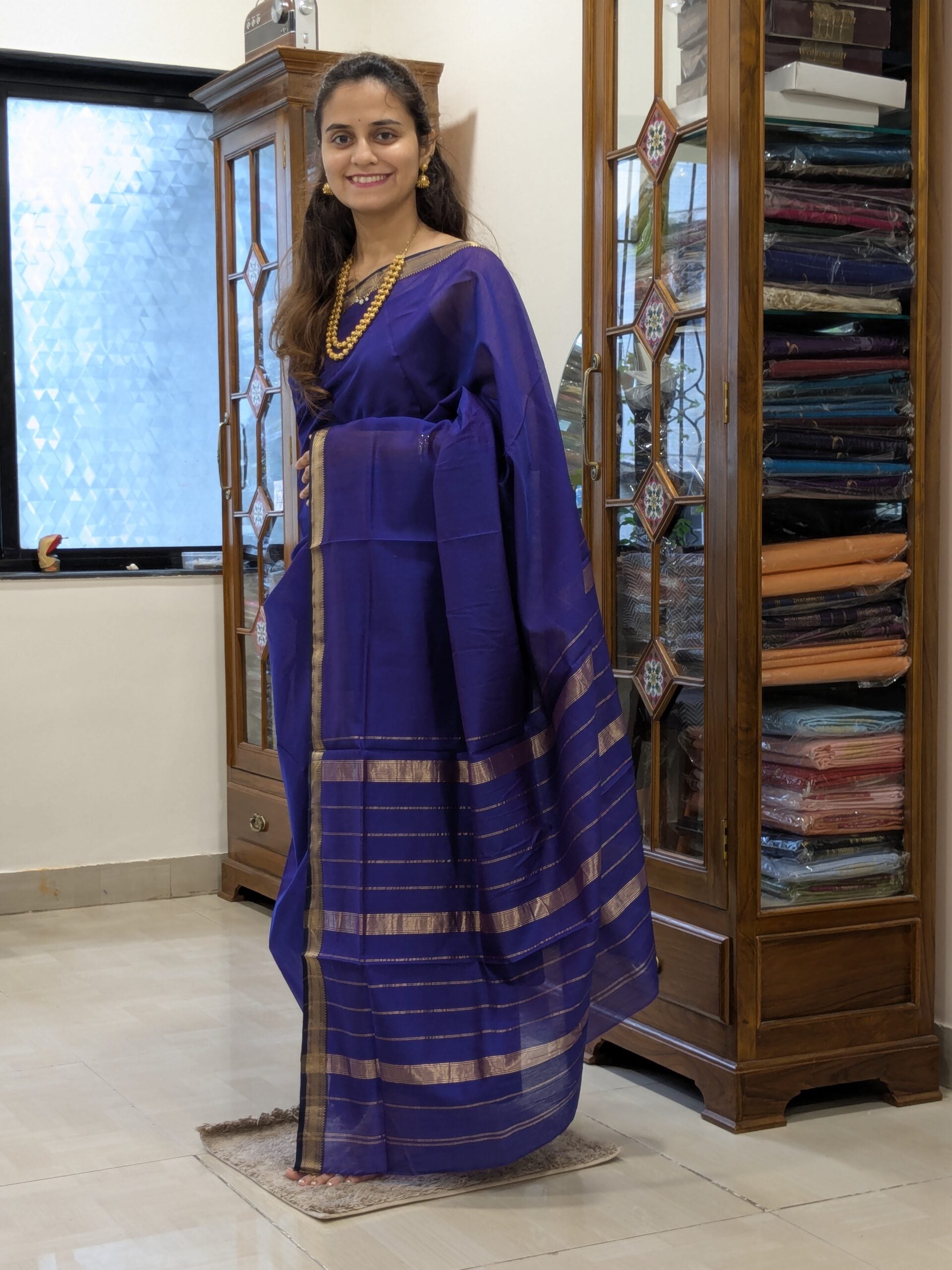 Full front view of handloom violet Maheshwari saree showcasing linear design and subtle traditional elegance.