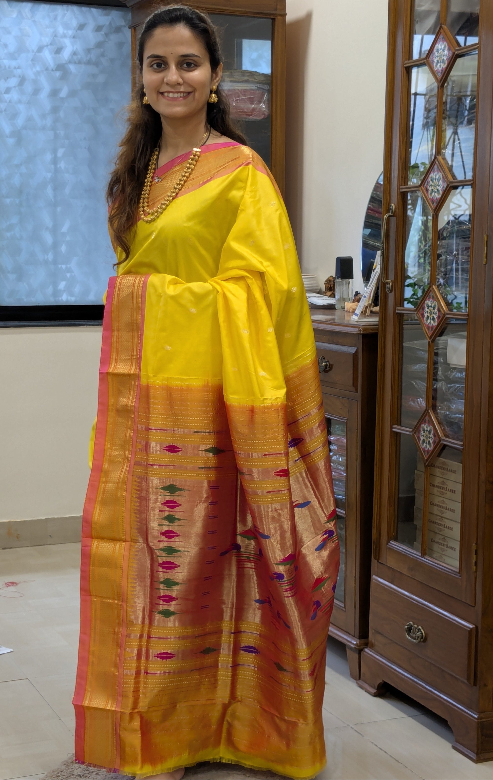 Full front view showcasing the lustrous yellow silk and regal Paithani craftsmanship.