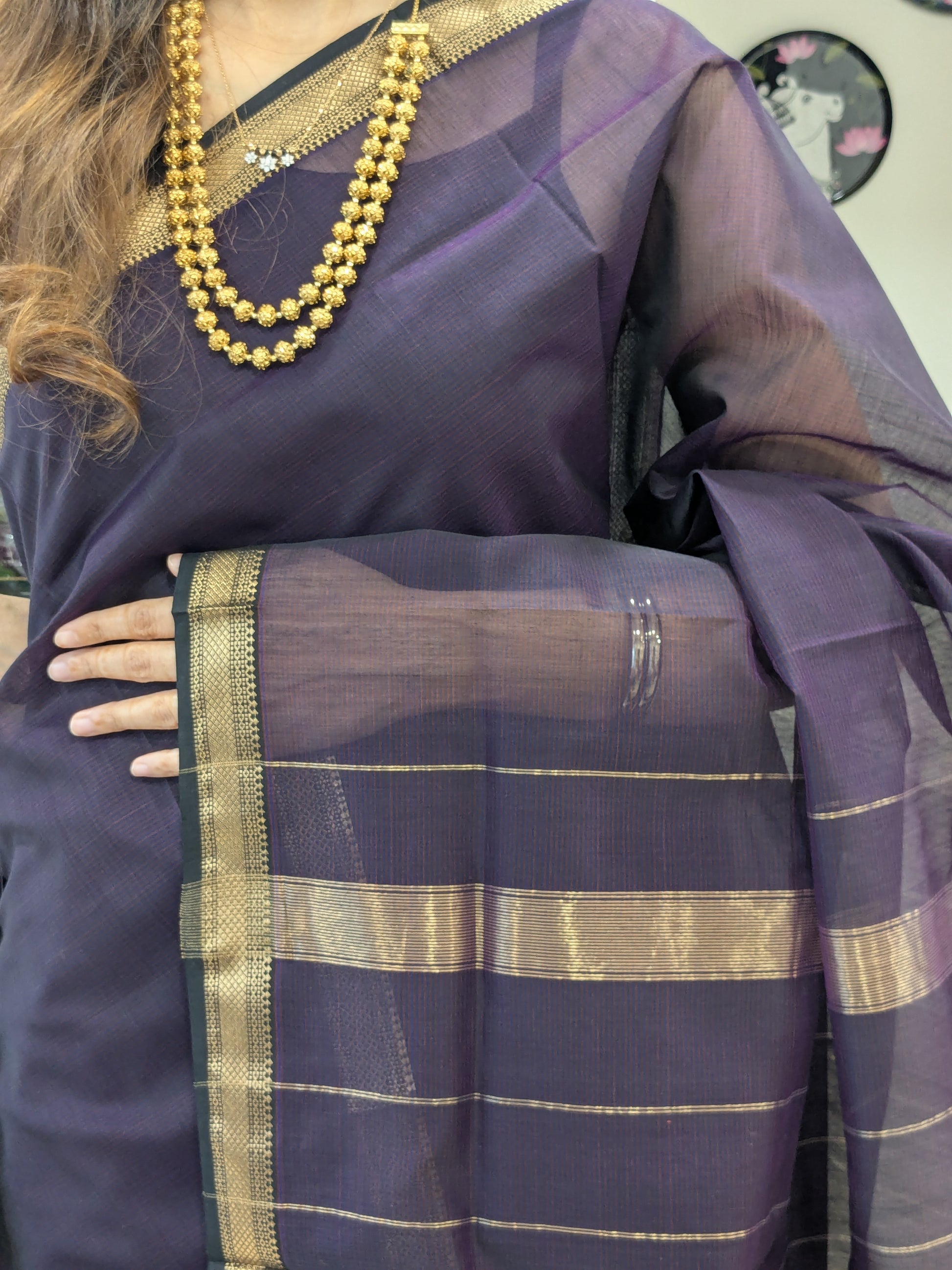Close-up of black Maheshwari silk-cotton saree with linear design, small zari border