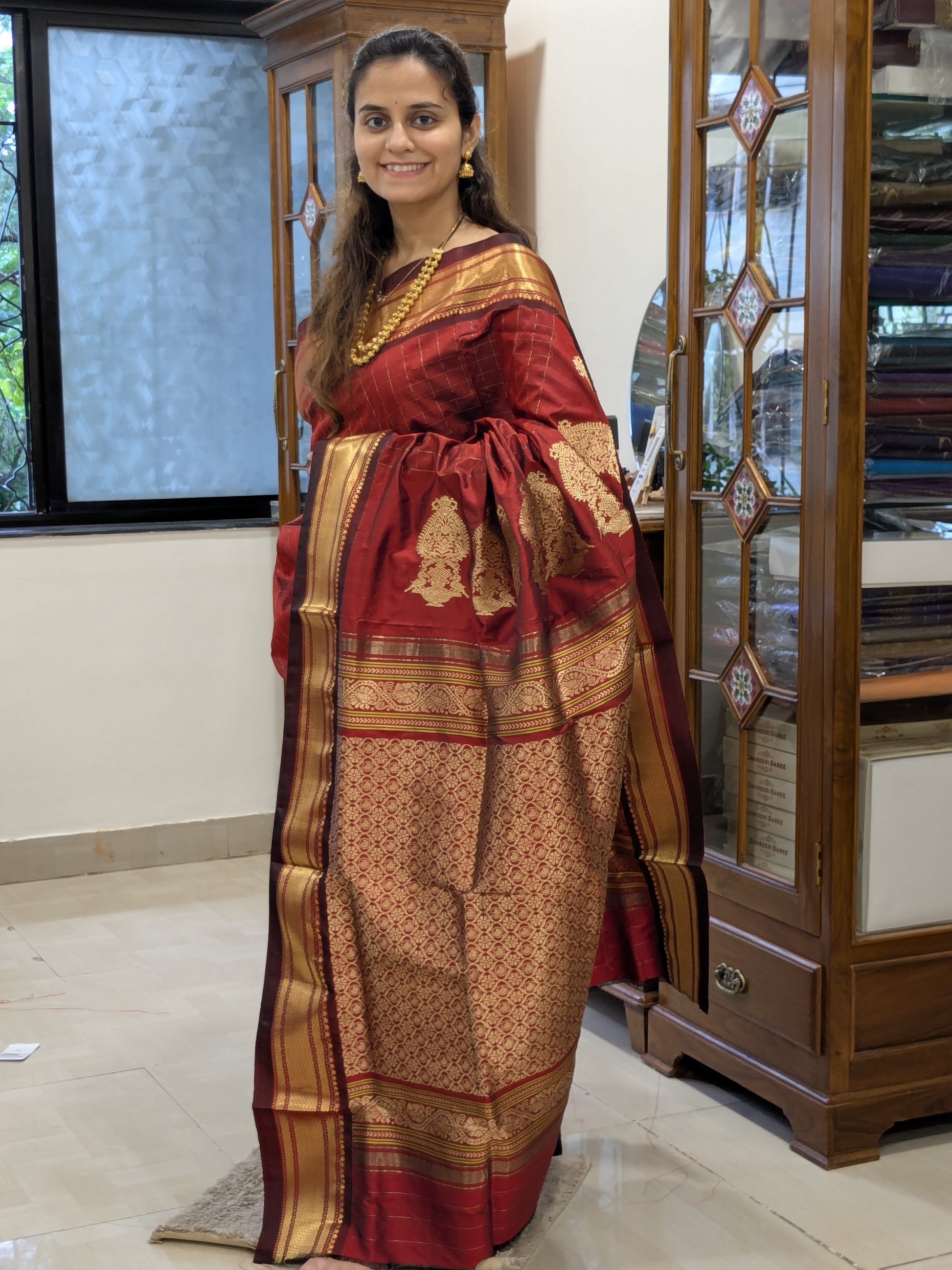 Full front view of luxurious bridal Paithani saree in rich red-brown silk.