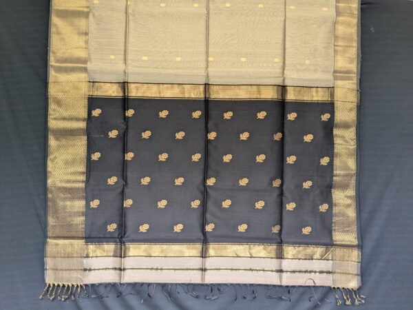 Detailed shot of buttidar pallu in black with fine floral motifs and shimmering threadwork.