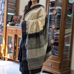 Full front view of handloom light yellow Maheshwari saree featuring subtle lines and contrasting black details.