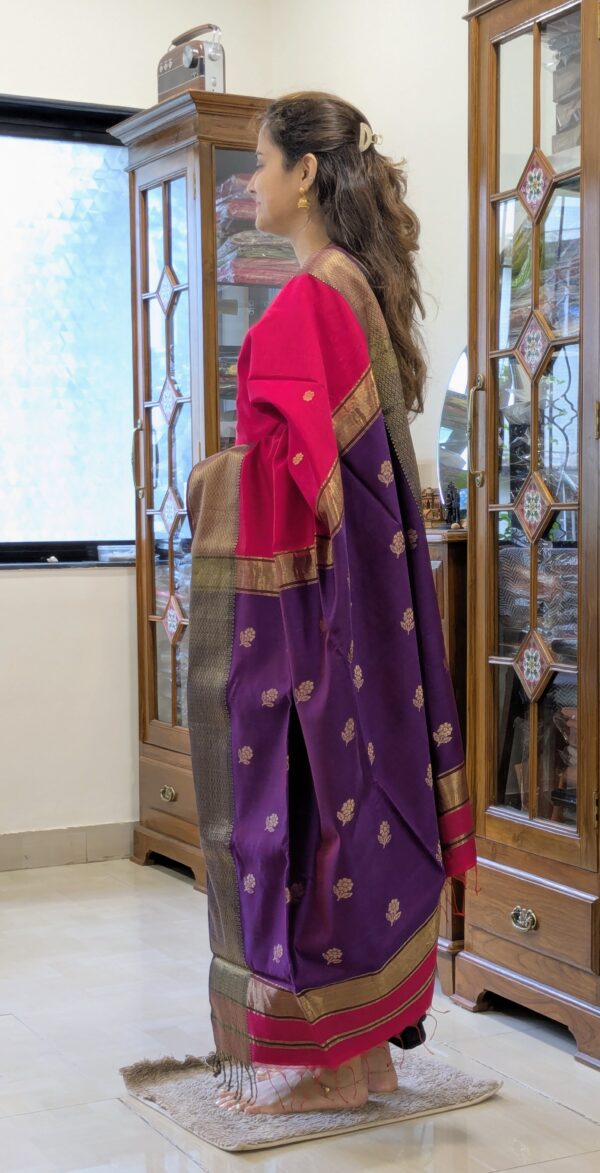 Side view of handloom saree showing soft drape, floral detailing, and elegant contrast in rani pink and purple.