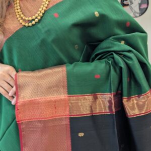 Close-up of green and black Maheshwari silk-cotton saree with flower butti motifs, wide & narrow border