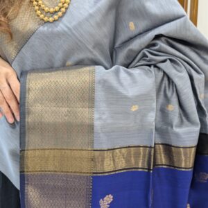 Close-up of grey and blue Maheshwari saree with flower butti, wide-narrow border