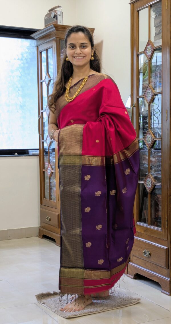 Full front view of festive silk-cotton Maheshwari saree in rani pink with traditional motifs and rich purple pallu.