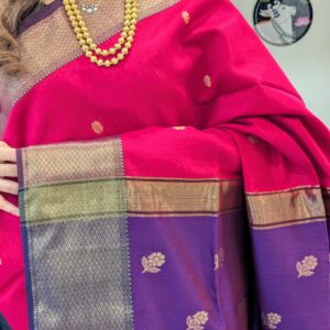 Close-up of rani pink and purple Maheshwari saree with flower butti, wide-narrow border