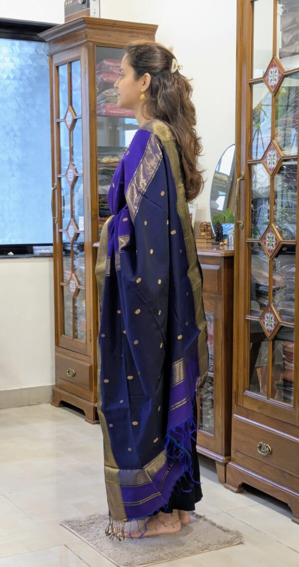 Side view of handloom saree showing elegant drape, floral detailing, and contrast color harmony.