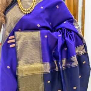 Close-up of purple and dark blue Maheshwari saree with flower butti motifs, wide-narrow border