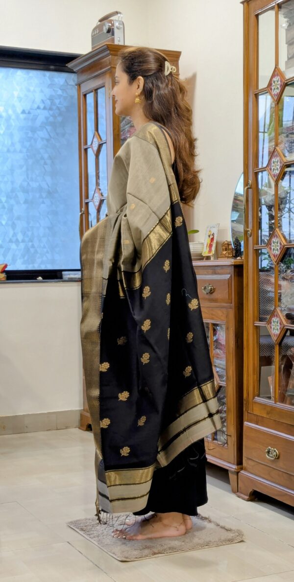 Side view of handloom saree in grey showing soft drape, traditional motifs, and elegant texture.