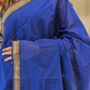 Close-up of royal blue Maheshwari saree with small checks, vintage pallu transition, and delicate zari border in silk-cotton blend.