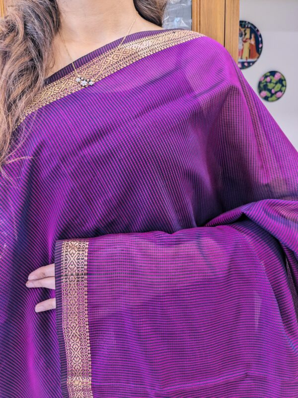 Close-up of magenta Maheshwari saree with small checks