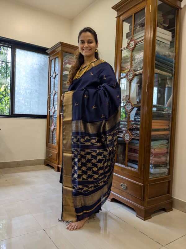 Full front view of festive silk-cotton Maheshwari saree in deep blue with intricate weaving and traditional design.