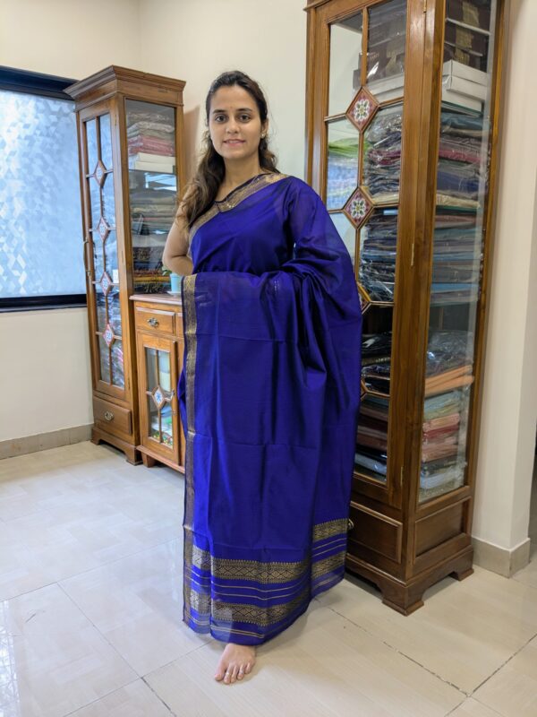 Full front view of purple silk-cotton Maheshwari saree featuring classic check pattern and elegant finish.
