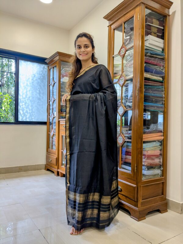 Full front view of classic black handloom Maheshwari saree featuring subtle check pattern and elegant finish.