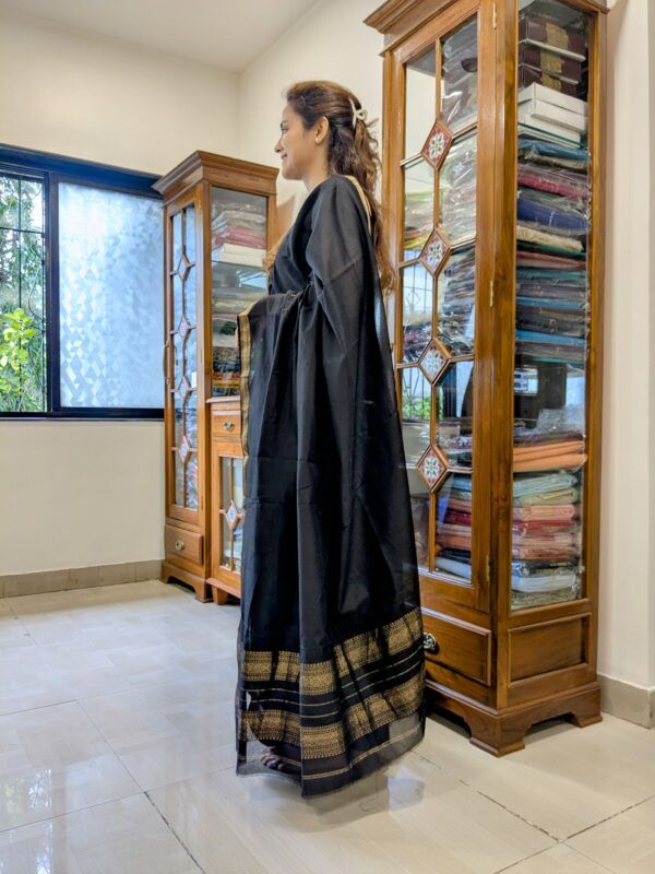 Side view of lightweight black saree showing smooth drape, soft texture, and refined weave.