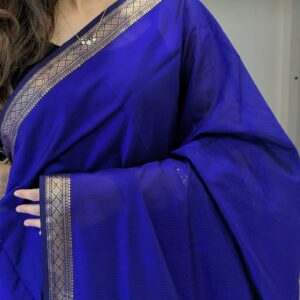 Close-up of purple Maheshwari handloom saree with small checks, delicate zari border