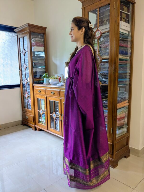 Side view of magenta silk-cotton saree showing soft drape, handwoven finish, and traditional styling.
