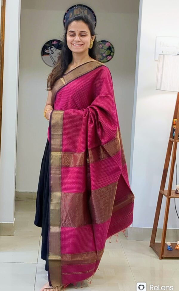 Full front view of festive dark rani pink handloom Maheshwari saree featuring shimmering zari checks and elegant texture.