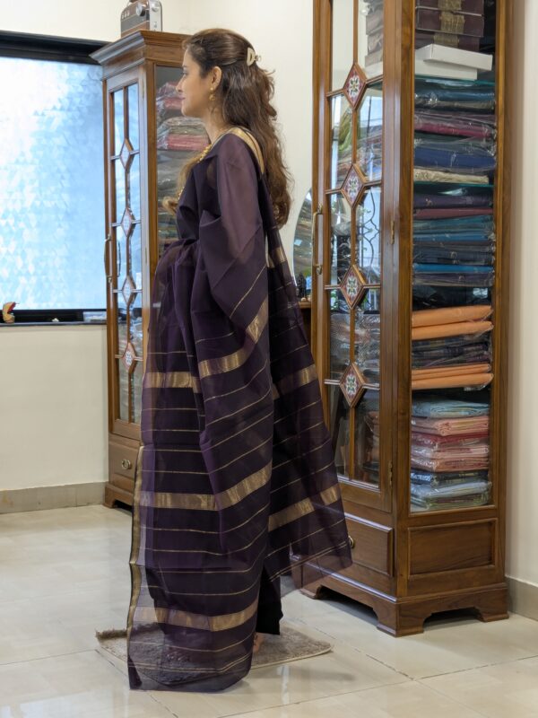 Side view of black silk-cotton saree showing fluid drape and refined handwoven texture.
