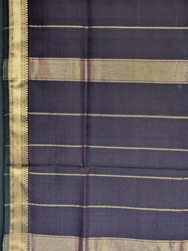 Detailed image of zari-lined pallu with clean striped patterns and delicate gold accents.