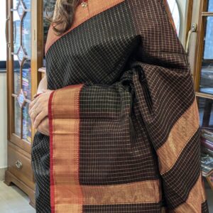 Close-up of black and red Maheshwari saree with zari checks, medium border